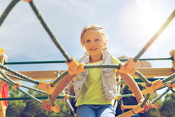 Image showing happy little girl climbing on children playground