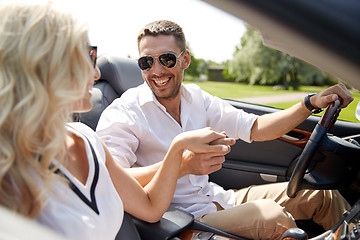 Image showing happy man and woman driving in cabriolet car