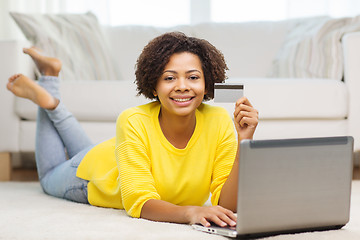 Image showing happy african woman with laptop and credit card