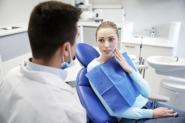 Image showing male dentist with woman patient at clinic