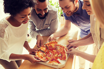 Image showing happy business team eating pizza in office