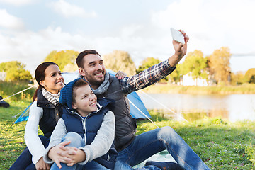 Image showing family with smartphone taking selfie at campsite