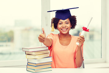 Image showing happy african bachelor girl with books and diploma