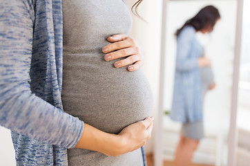 Image showing close up of pregnant woman looking to mirror