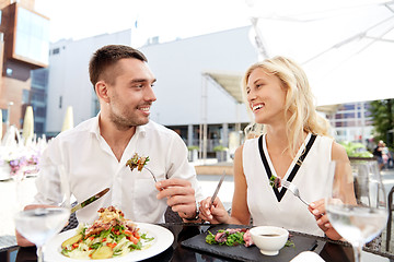 Image showing happy couple eating dinner at restaurant terrace