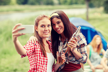 Image showing happy women taking selfie by smartphone at camping
