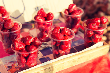 Image showing strawberry in plastic cups at street market