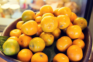Image showing basket of fresh ripe juicy oranges at kitchen