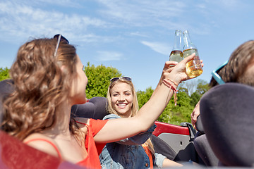 Image showing happy friends driving in cabriolet car with beer