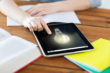 Image showing close up of student with tablet pc and notebook