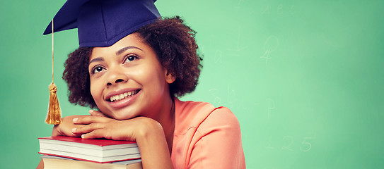 Image showing happy african bachelor girl with books at school