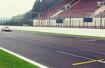 Image showing close up of car driving on speedway track or road