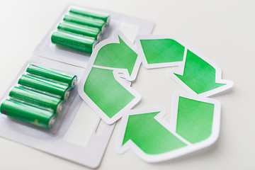 Image showing close up of batteries and green recycling symbol