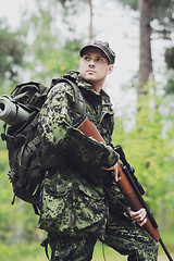 Image showing young soldier or hunter with gun in forest