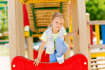 Image showing happy little girl climbing on children playground