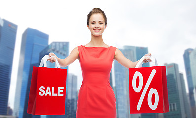 Image showing happy woman with shopping bags over singapore city