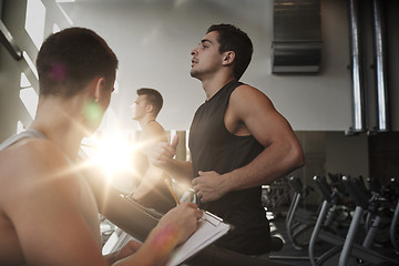 Image showing men exercising on treadmill in gym