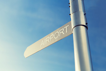 Image showing close up of airport signpost over blue sky