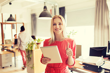 Image showing woman with tablet pc showing thumbs up at office