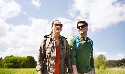 Image showing happy couple with backpacks hiking outdoors