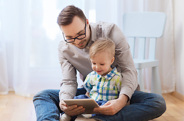 Image showing father and son with tablet pc playing at home