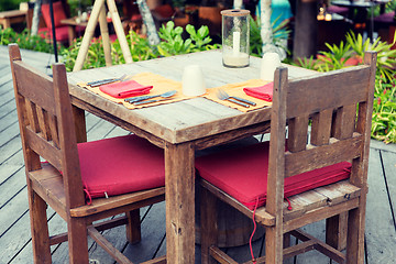 Image showing close up of cutlery with glass and napkin on table