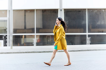 Image showing smiling young woman or girl calling on smartphone