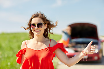 Image showing women with broken car hitchhiking at countryside