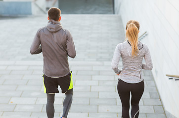 Image showing couple running downstairs on city stairs