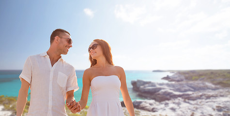 Image showing happy smiling couple over summer beach and sea