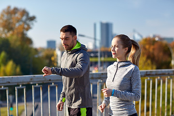 Image showing couple running over city highway bridge