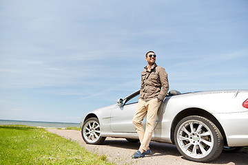 Image showing happy man near cabriolet car outdoors