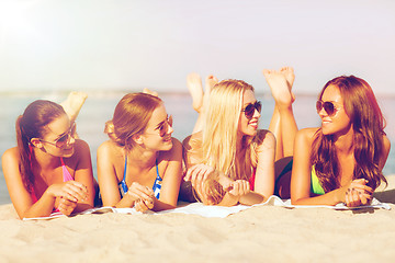 Image showing group of smiling women in sunglasses on beach