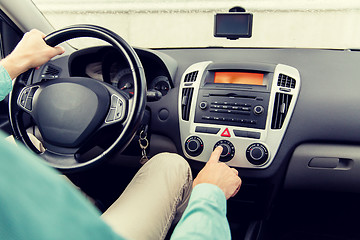 Image showing close up of male hand using climate control in car