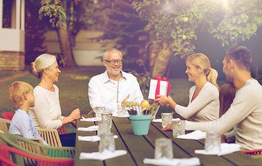 Image showing happy family having holiday dinner outdoors