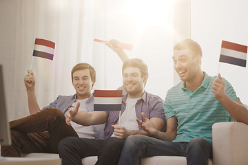 Image showing happy male friends with flags and vuvuzela