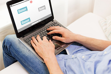 Image showing close up of man typing on laptop computer at home