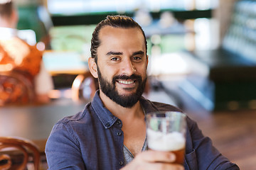 Image showing happy man drinking beer at bar or pub