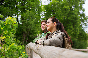 Image showing smiling couple with backpacks in nature