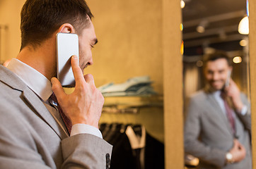 Image showing close up of man calling on cellphone at store