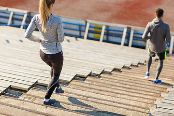 Image showing close up of couple running downstairs on stadium