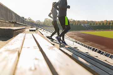 Image showing close up of couple running downstairs on stadium