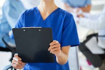 Image showing close up of doctor with clipboard at hospital