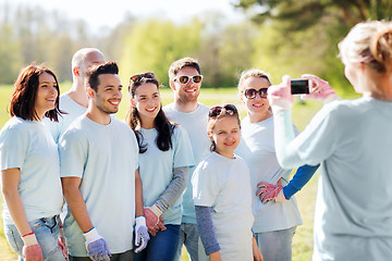 Image showing group of volunteers taking picture by smartphone