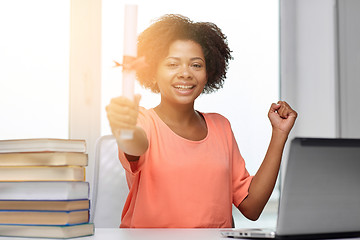 Image showing happy african woman with laptop, books and diploma