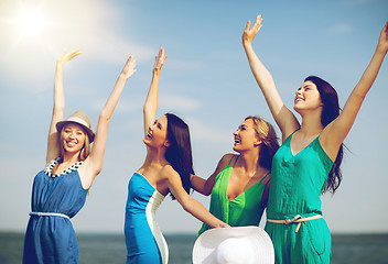 Image showing girls looking at the sea with hands up