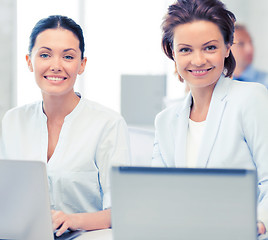 Image showing group of people working with laptops in office