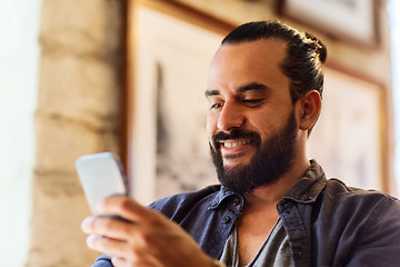 Image showing man with smartphone at bar or pub