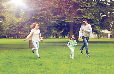 Image showing happy family walking in summer park