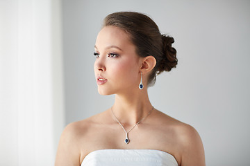 Image showing beautiful asian woman with earring and pendant